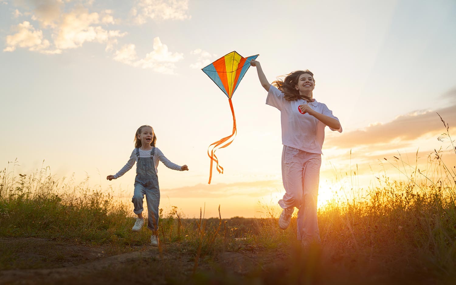 Happy kids running with a kite
